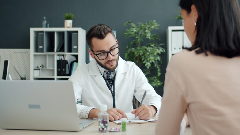 Doctor consulting a patient about a skin concern during a clinic visit