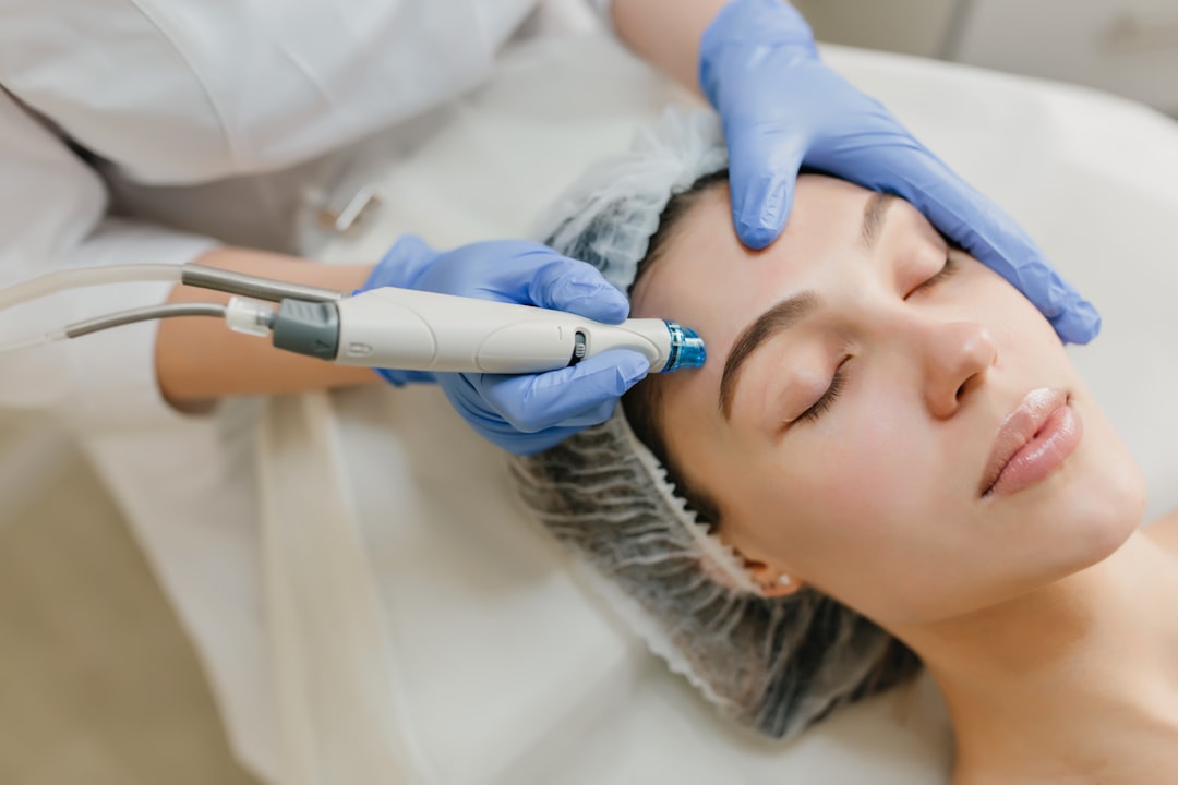 Woman receiving a cosmetic skin tightening facial treatment at a clinic
