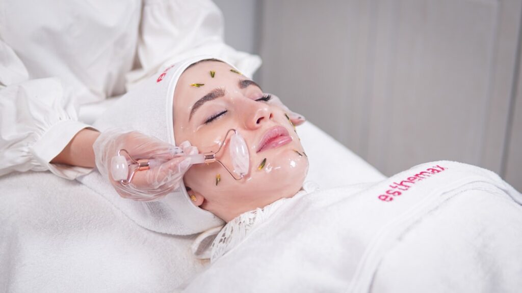 Woman having a facial mask treatment applied at a skincare clinic
