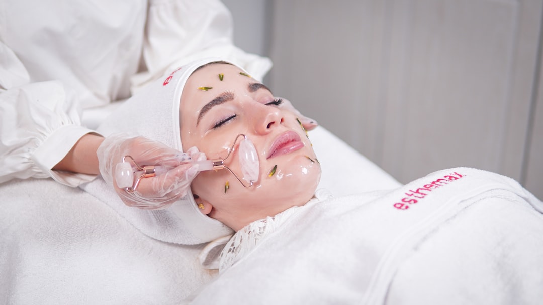 Woman having a facial mask treatment applied at a skincare clinic