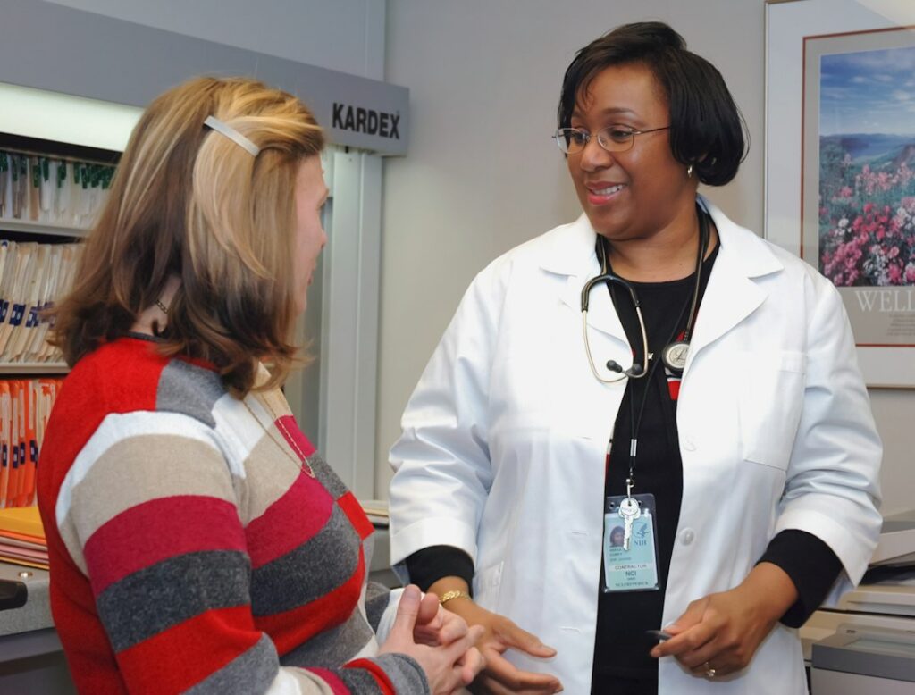 Doctor in a clinic consulting with a patient about a skin condition
